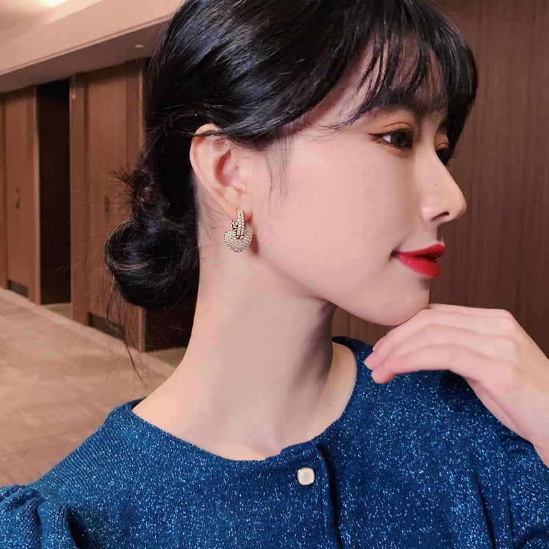 Gold flower-shaped earrings with cubic zirconia