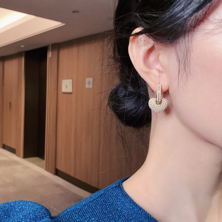 Gold flower-shaped earrings with cubic zirconia