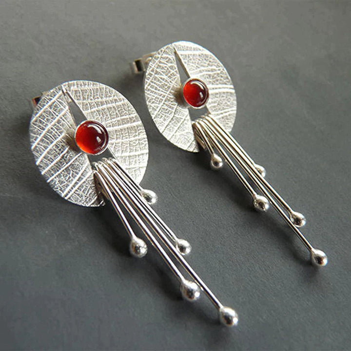 Dangling earrings with hollow red stone